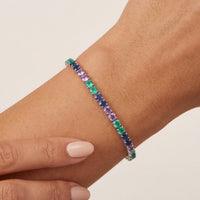 Silver tennis bracelet with multicolor gemstone row on wrist