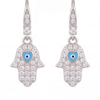 Silver-tone hamsa drop earrings with blue evil-eye enamel and crystal detailing.