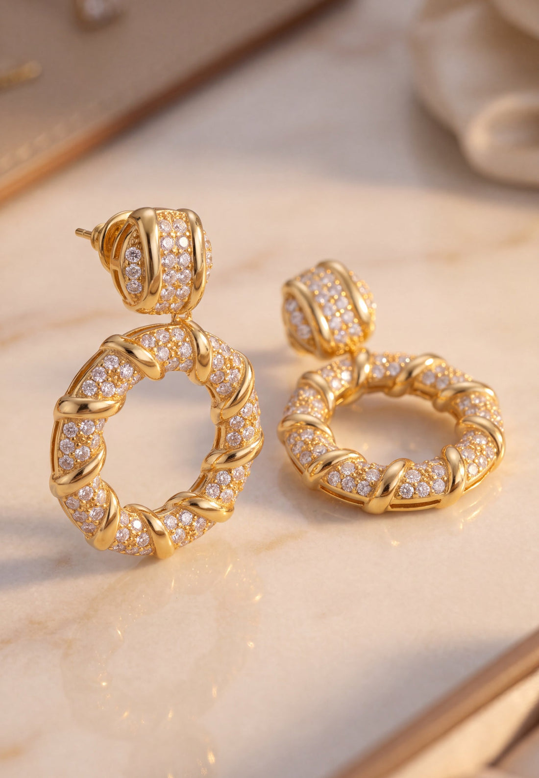Gold drop earrings with crystal-studded hoop design