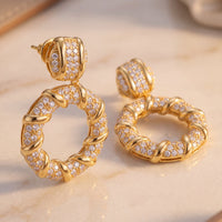 Gold drop earrings with crystal-studded hoop design