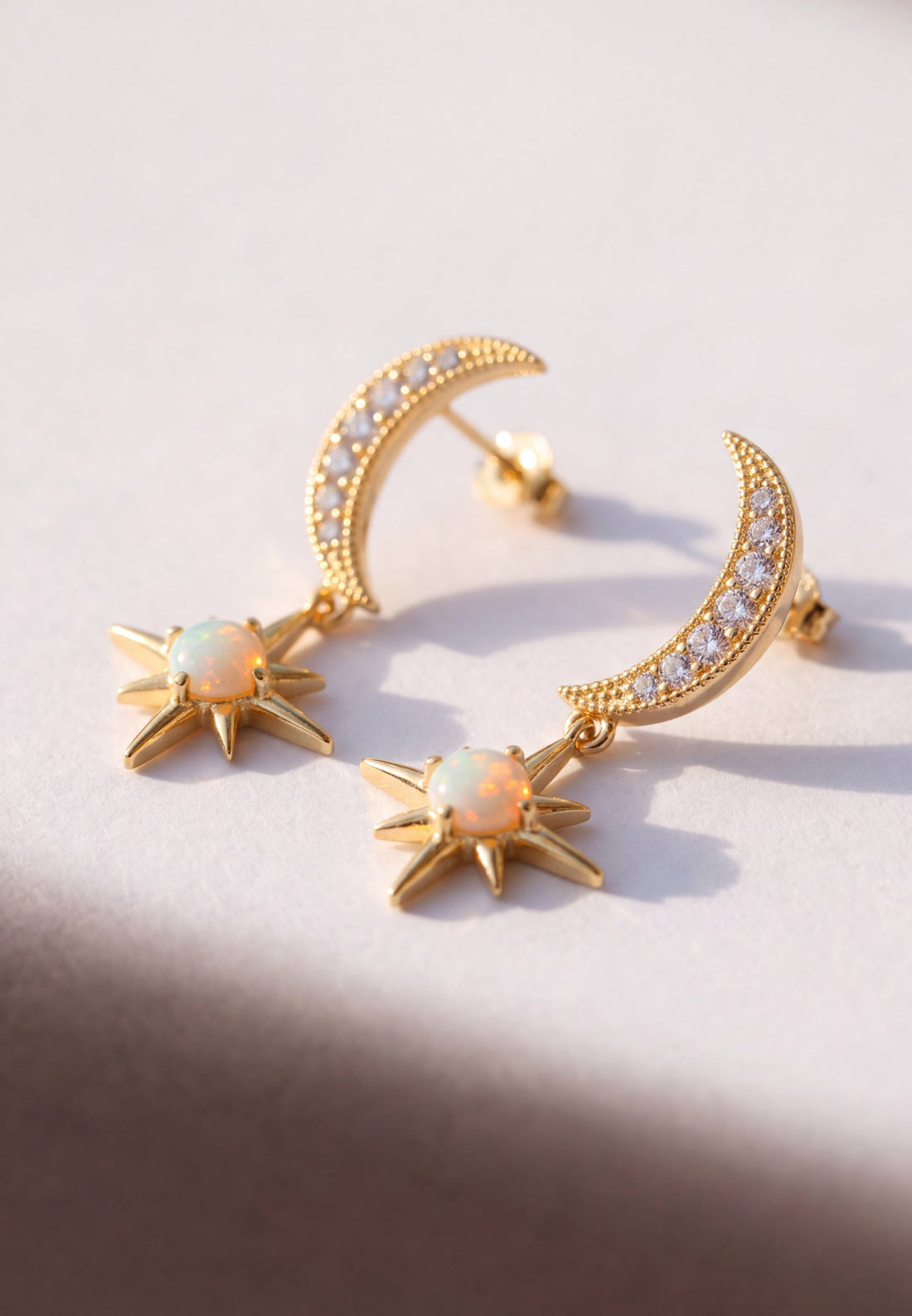Gold crescent moon and starburst opal drop earrings