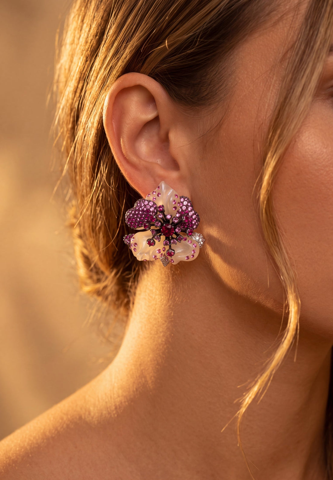 Rhinestone flower stud earrings worn on ear, pink and white floral cluster, silver tone