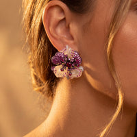 Rhinestone flower stud earrings worn on ear, pink and white floral cluster, silver tone