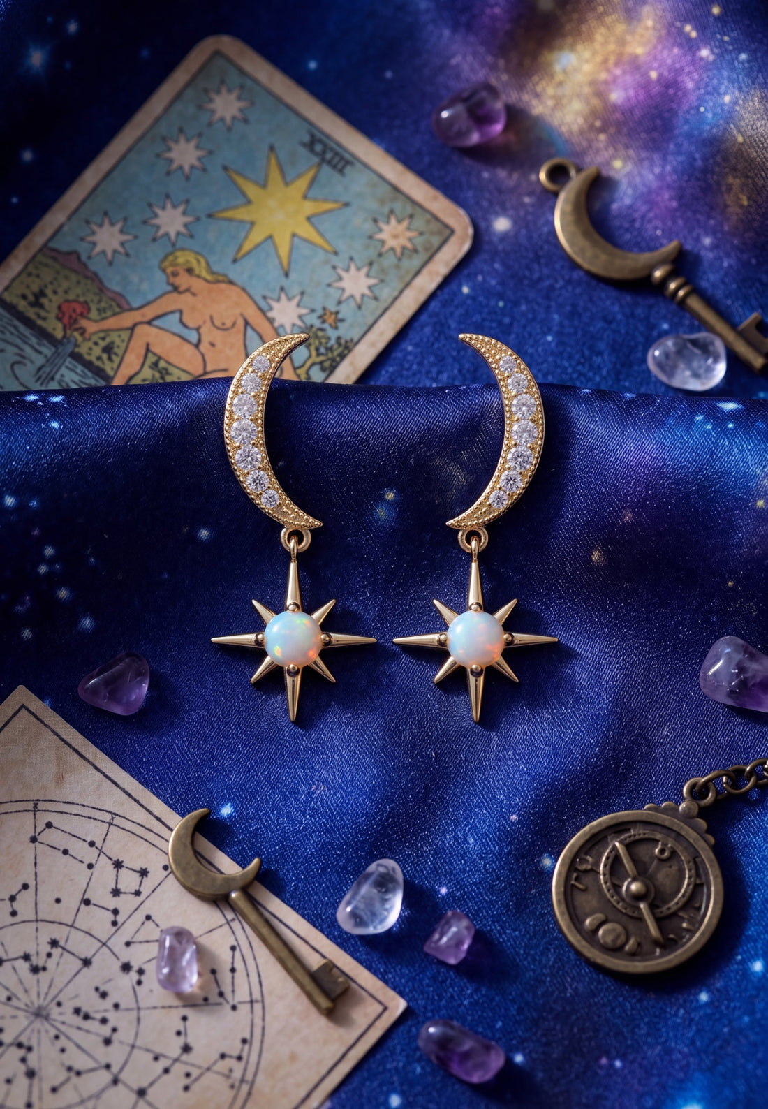 Gold crescent moon and starburst opal drop earrings with sparkling crystal accents