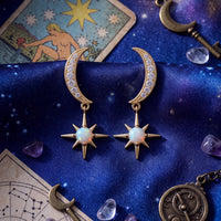 Gold crescent moon and starburst opal drop earrings with sparkling crystal accents