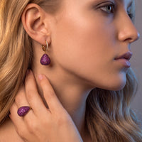 Gold pear-drop gemstone earrings with purple teardrop crystals and hinged hook