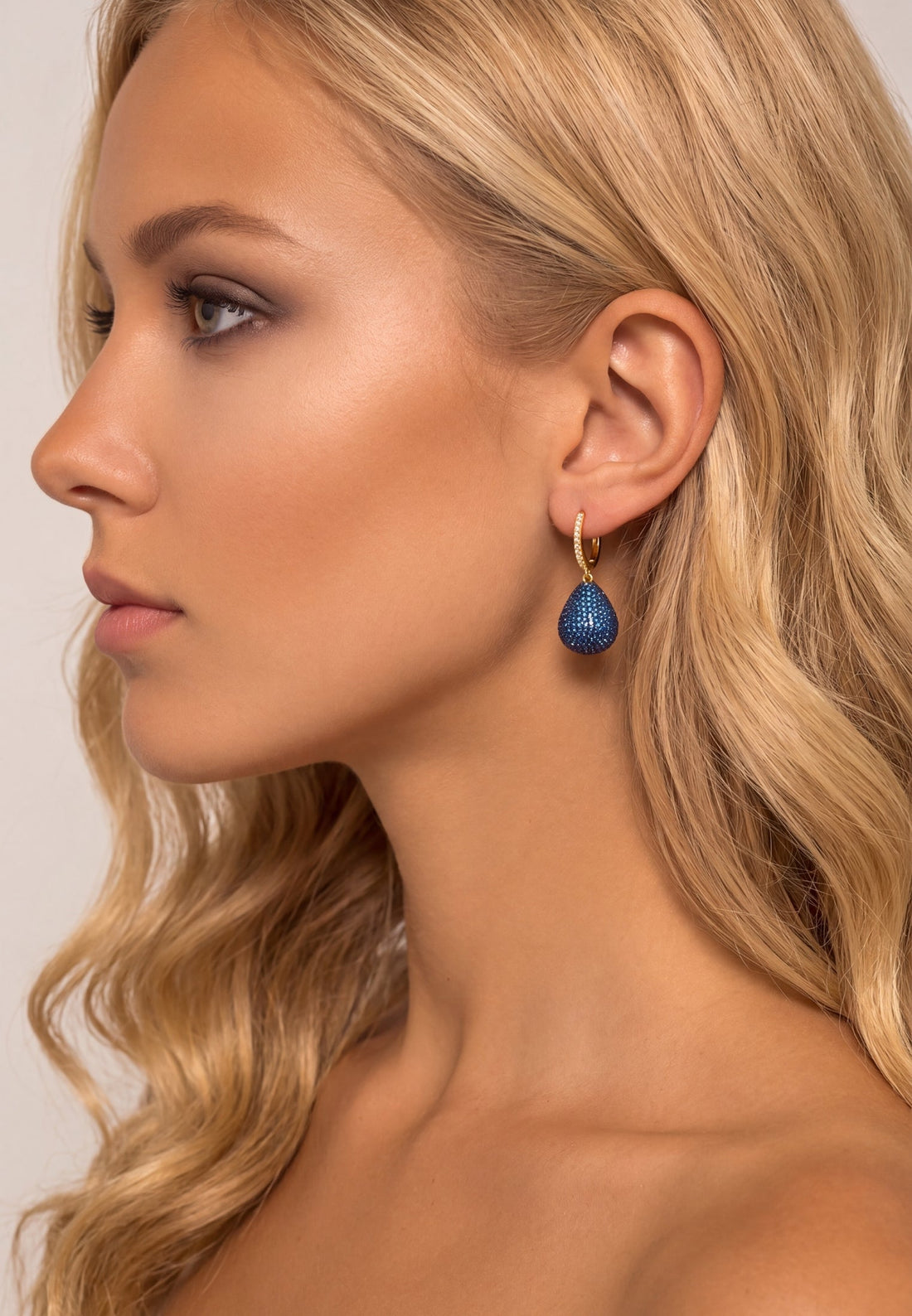 Pear drop gemstone earrings with gold hooks and sapphire blue stones