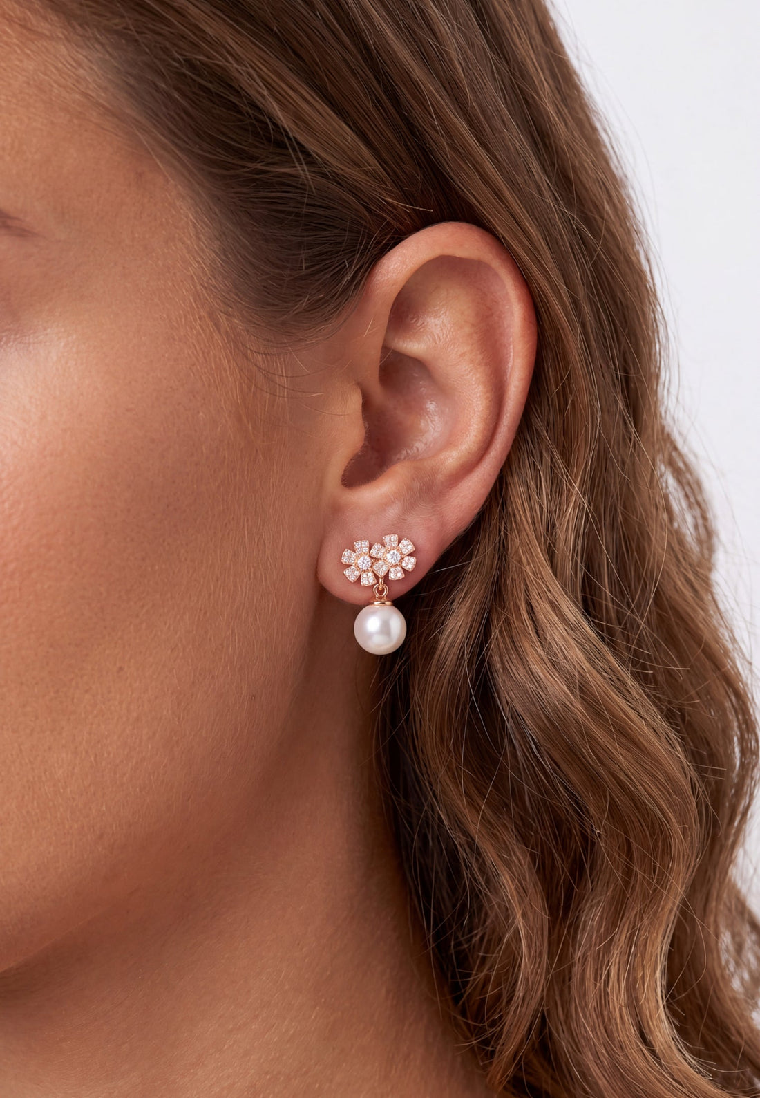 Rose gold flower stud earrings with small white pearl drops
