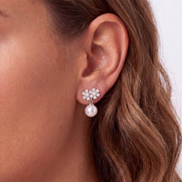 Floral crystal stud earrings with white pearl drop, silver tone
