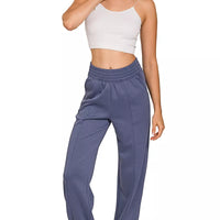 Indigo-blue scuba elastic-waist joggers with pockets and relaxed tapered legs