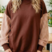 Dark brown loose tunic sweatshirt with plaid check sleeves and ribbed crew neck