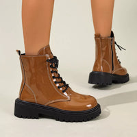 Yellow-brown lace-up block heel boots with black laces, glossy finish, and chunky tread
