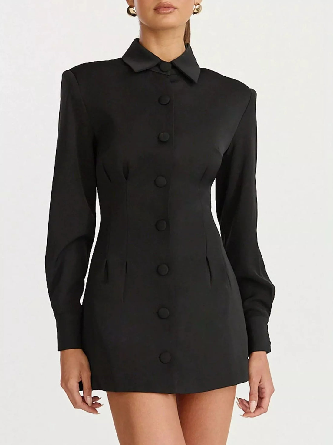 Black blazer mini dress with pointed collar and vertical row of round buttons.
