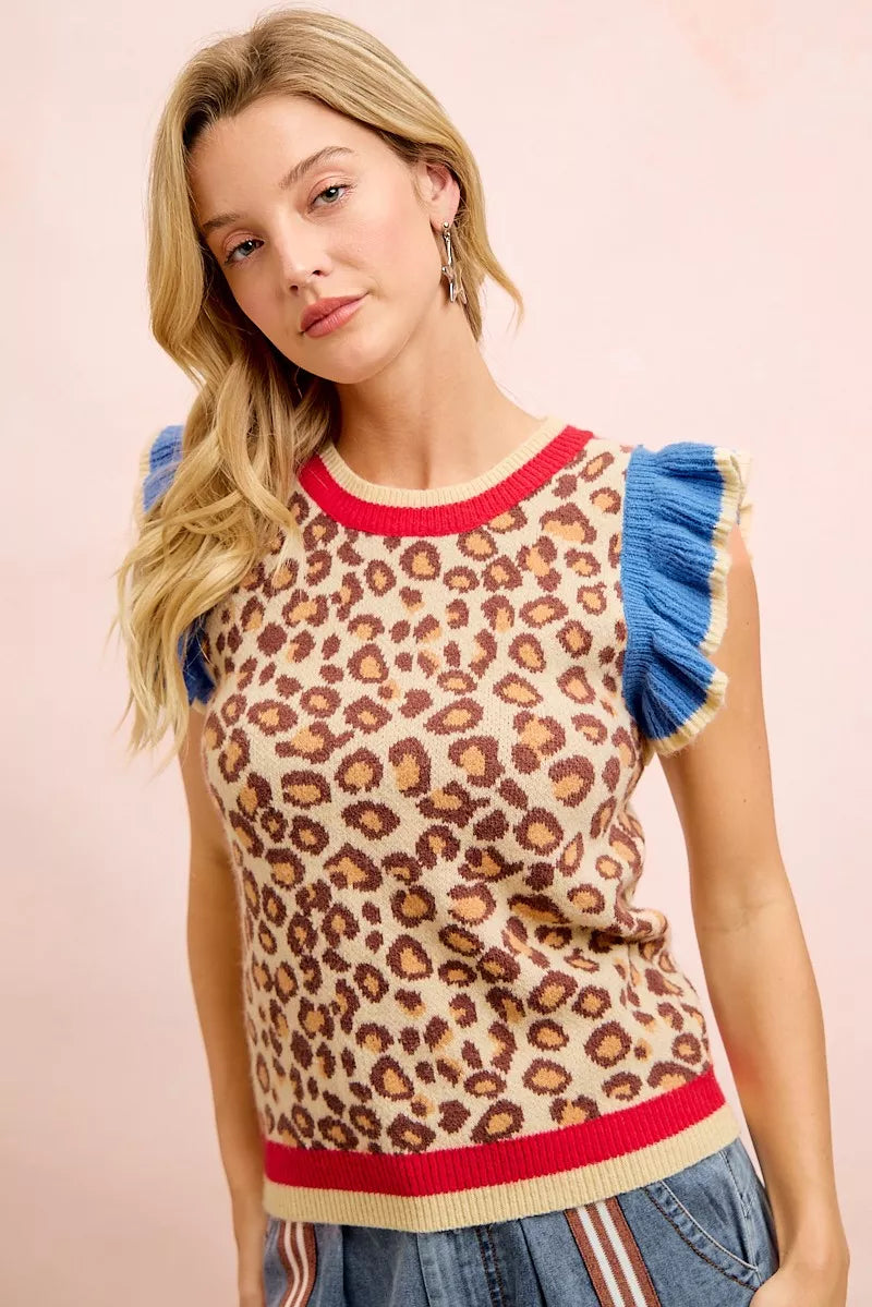 Leopard print knit top with blue ruffled sleeves and red neckline rib trim