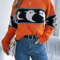 Orange textured sweater featuring a black-and-white ghost pattern and ribbed hem