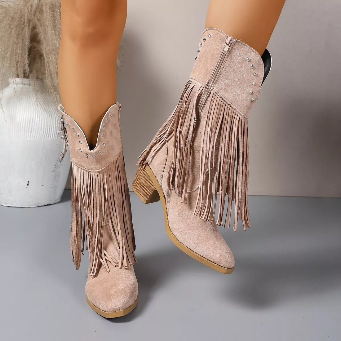 Taupe suede fringe boots with studded collar and block heel, side zipper detail