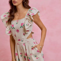 Ivory floral romper with ruffled cap sleeves and cut-out waist, pink and green rose print