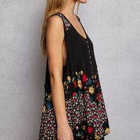 Black ribbed tank top with floral woven patch panels and asymmetrical hem