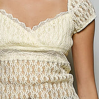 Natural lace short-sleeve top close-up with sweetheart neckline and floral pattern