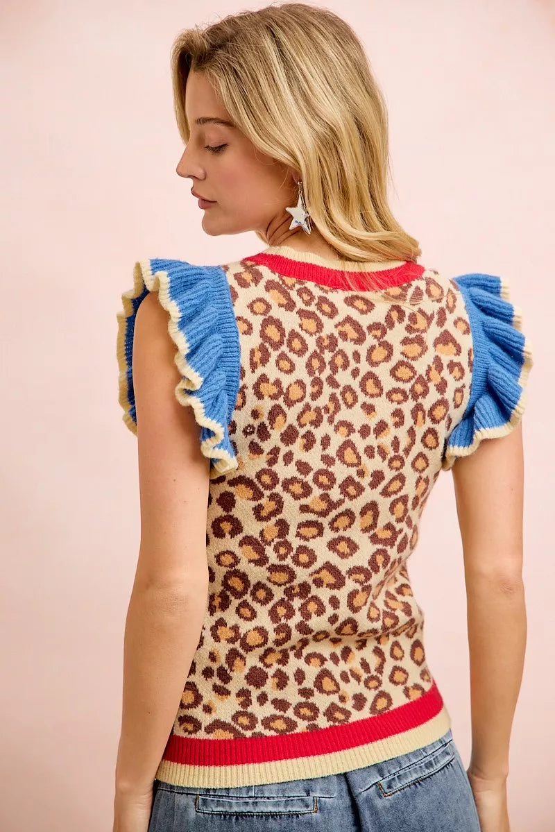 Leopard print knit top with blue ruffled sleeves and ribbed red hem