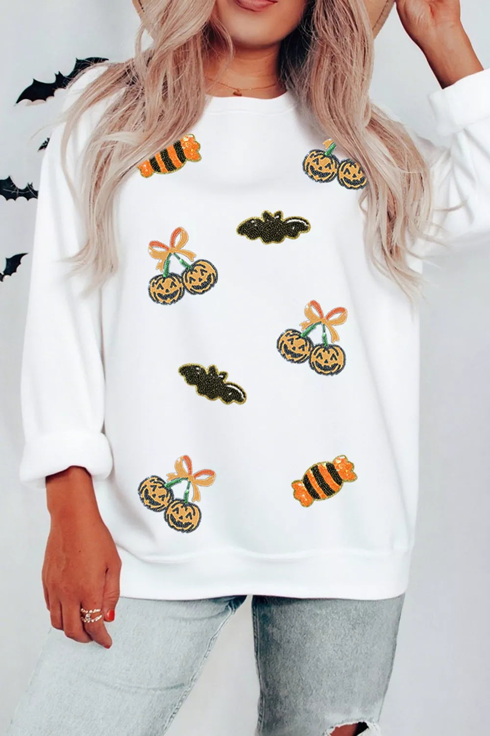 White sequin pullover sweatshirt with scattered jack-o&