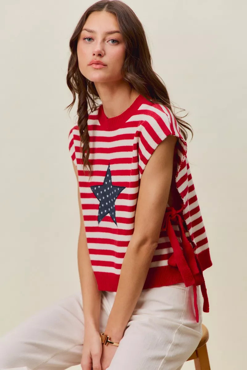 Red and ivory striped sleeveless knit vest top with navy star patch and side ties