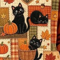 Orange V-neck sweater close-up: black cats with pumpkins, leaves, and patchwork blocks