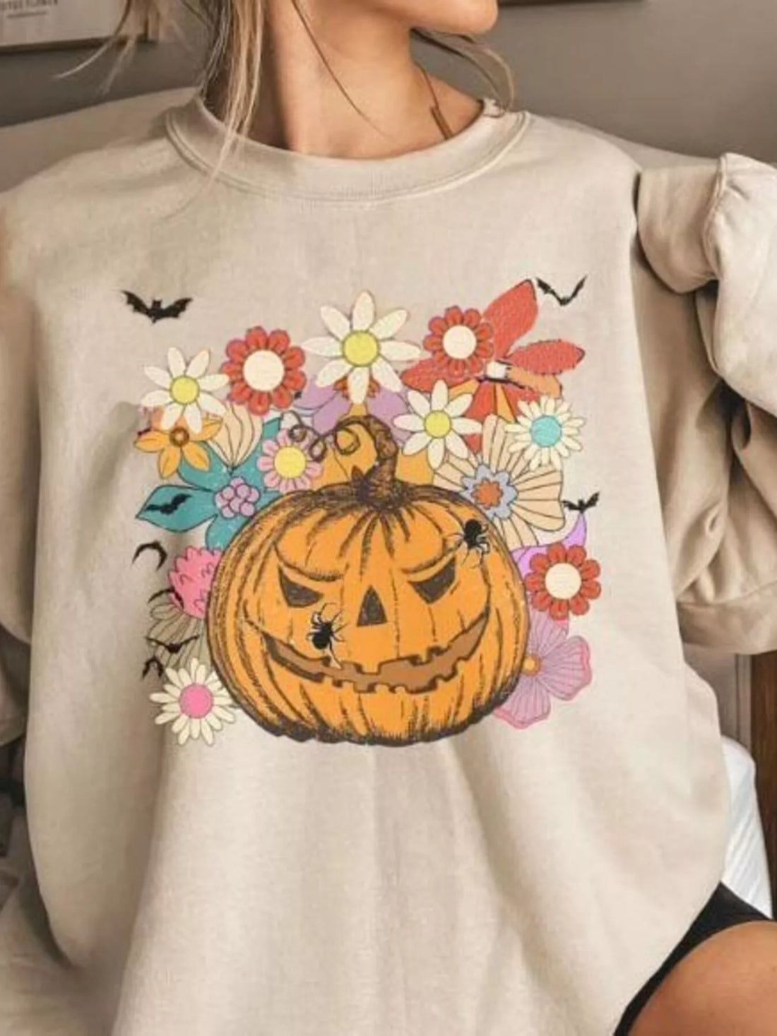 Tan crewneck sweatshirt with pumpkin floral graphic front