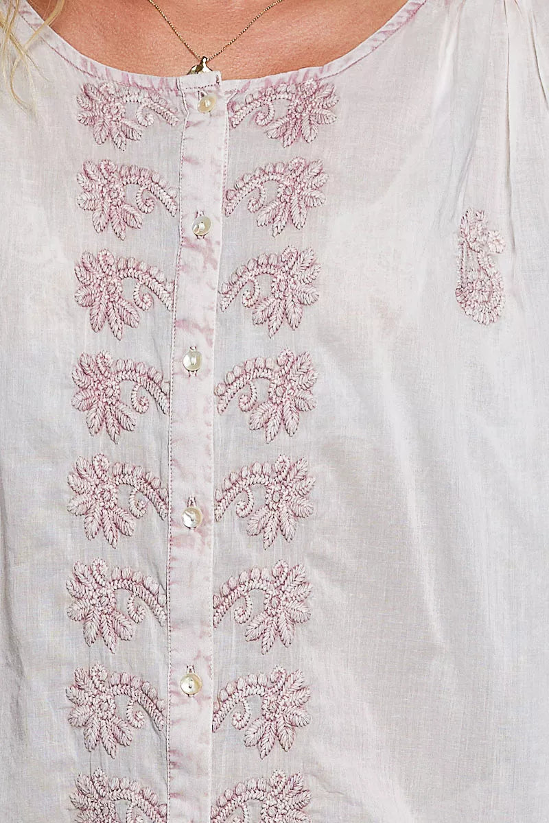 Blush floral embroidery on off-white shirt front with buttoned placket
