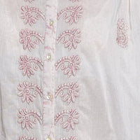 Blush floral embroidery on off-white shirt front with buttoned placket