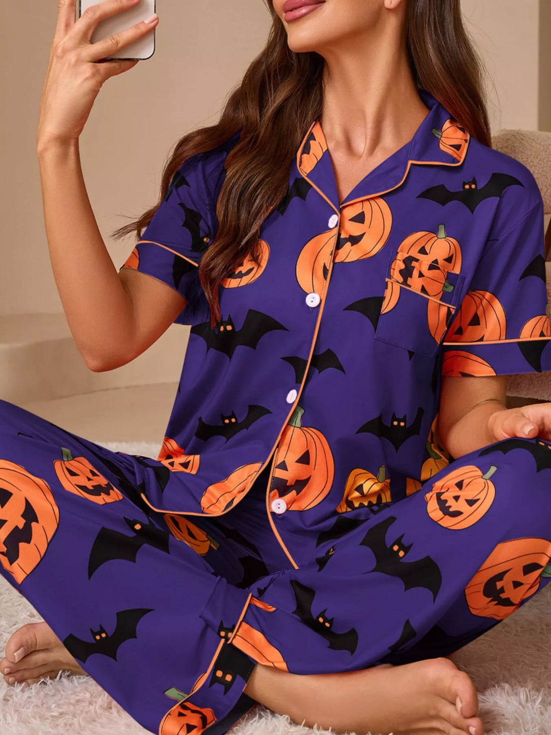 Halloween pajama set in purple with orange pumpkin and bat prints; button-front short-sleeve top