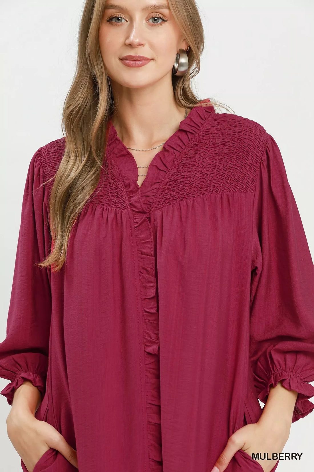 Mulberry mini dress close-up of smocked ruffle V-neck and button placket