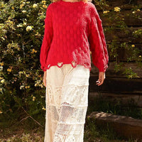 Red checkered distressed edge sweater with scalloped hem and long sleeves