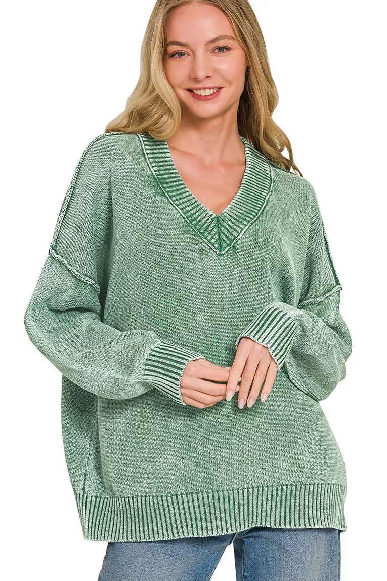 Dark green washed oversized V-neck sweater with ribbed neckline, cuffs, and hem