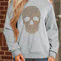 Gray mock-neck pullover sweatshirt with gold-toned skull graphic on the front
