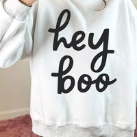 Reversible white mock neck tunic sweatshirt with "hey boo" black script graphic