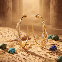 Gold snake hoop earrings with colorful stone accents and sparkling details