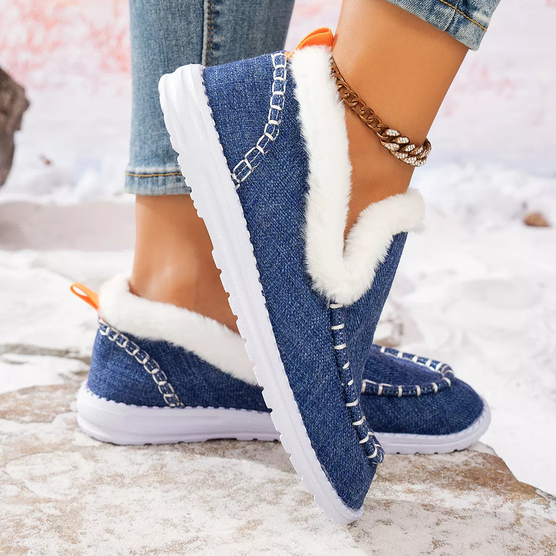 Dark blue faux fur lined round toe slip-on shoes with white fur trim and soles