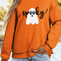 Orange mock neck sweatshirt with white ghost graphic and black lettering