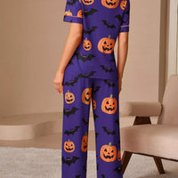 Halloween pajama set: purple button-front top and pants with orange pumpkin and bat repeat print