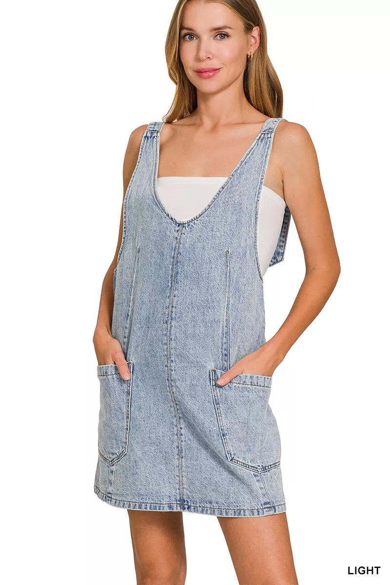 Light wash denim overall dress with adjustable straps and two front pockets