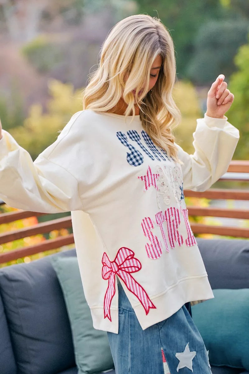 Cream crewneck sweatshirt with stars-and-stripes patch-style graphic, long sleeves