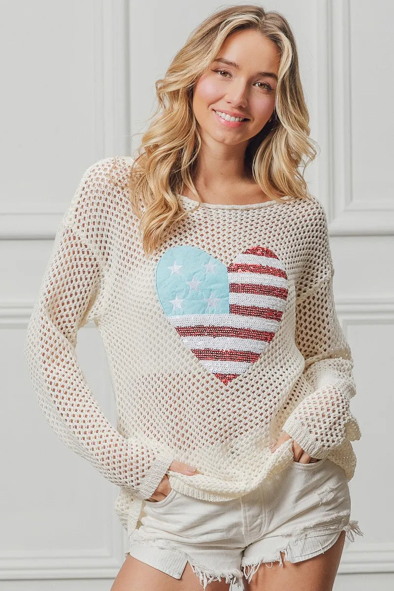 Off-white sequin heart knit top with American flag motif, long sleeves.