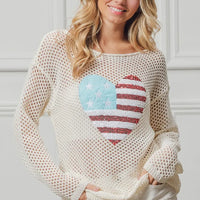 Off-white sequin heart knit top with American flag motif, long sleeves.