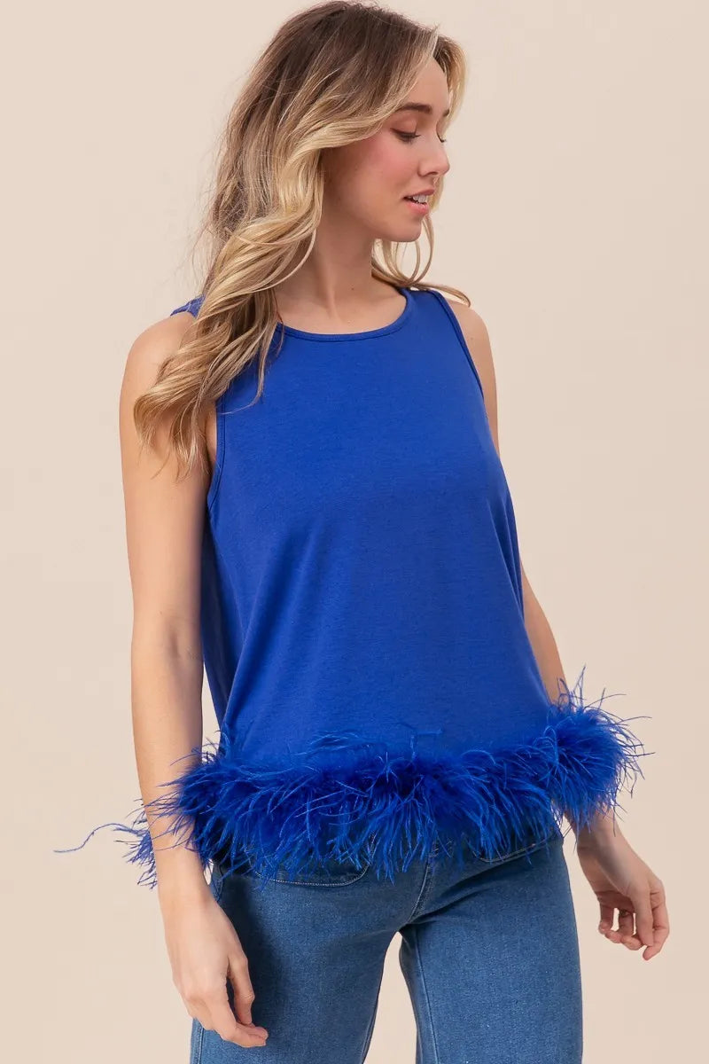 Royal blue sleeveless top with shaggy faux feather trim hem, side view