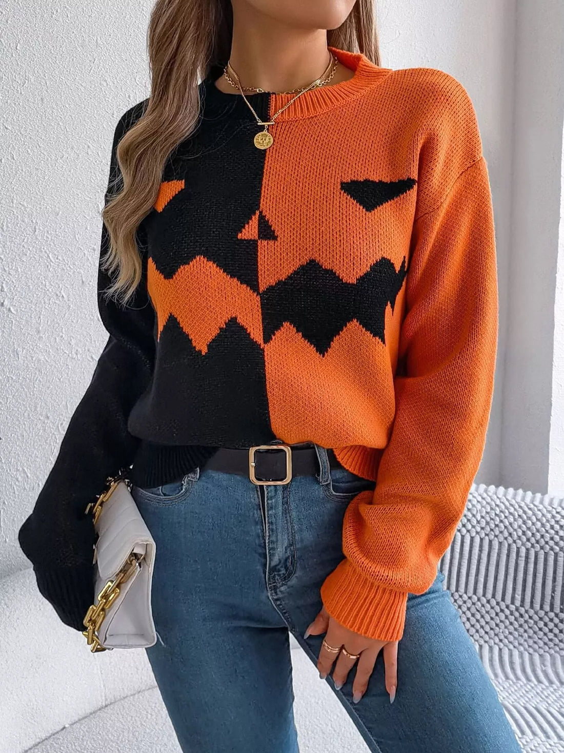 Two-tone pumpkin face graphic sweater, orange/black zip-front knit, long sleeves