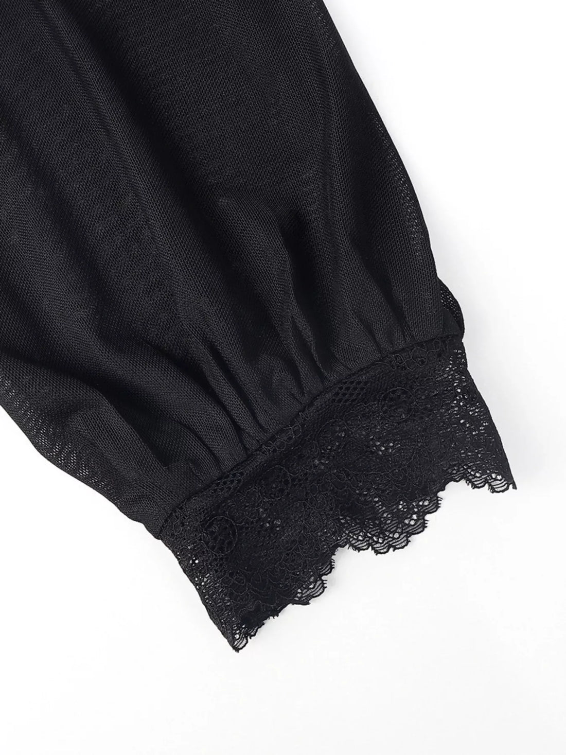 Black sheer sleeve cuff with lace trim on a velvet blouse
