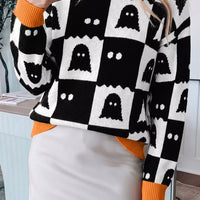 Ghost face checkerboard sweater in black and white with orange ribbed crew neck