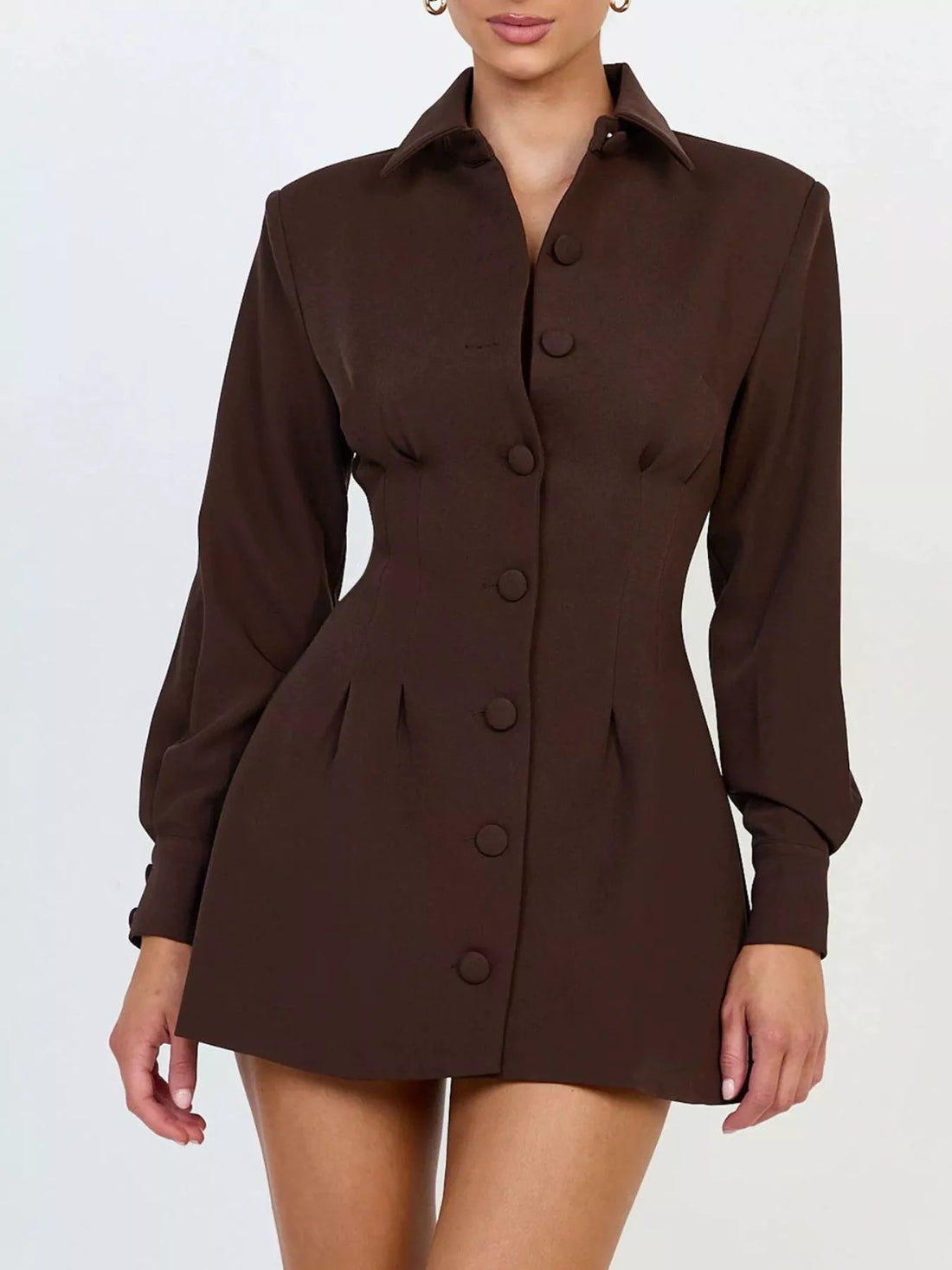 Brown blazer mini dress with notched lapel collar, long sleeves, and buttoned bodice.