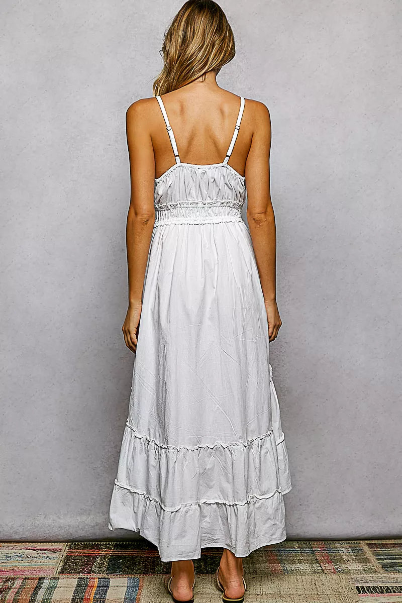 Back view: ivory tiered cami midi dress with spaghetti straps and smocked waist